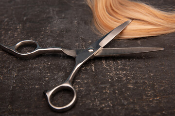 Hairdressing tools with curl on a black background