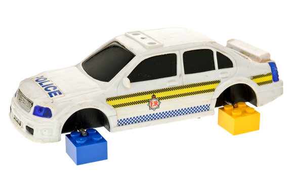 Toy Police Patrol Car With No Wheels On A White Background