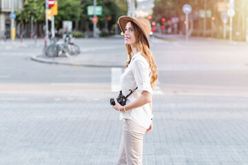 Woman photographer lookig for a spot to photograph with a vintage camera. Female professional...