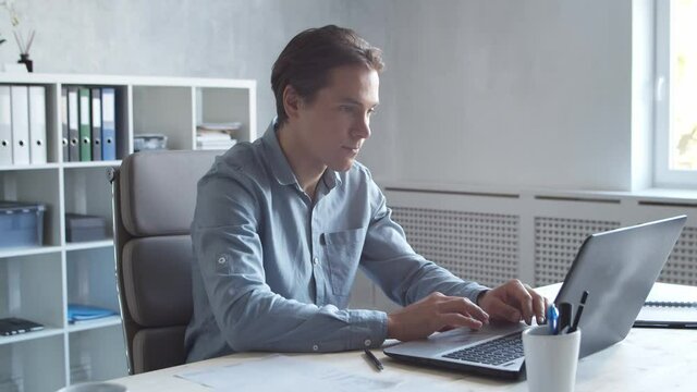 Business persons is work alone in modern office using computer technology. Workplace of young businessman.