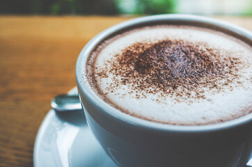 closeup coffee cup on wood table bar in restaurant or cafe with copy space. fresh beverage.