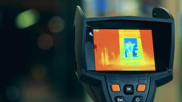 Screen of a thermographic camera showing people's thermal image