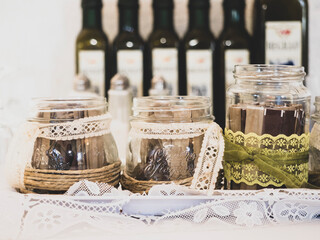 jars decorated with sugar and bottles of oil front view