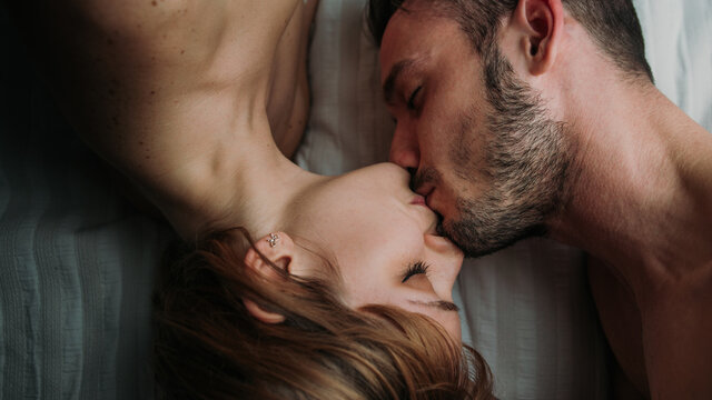 Romantic couple kissing lying on bed - Boyfriend and girlfriend in love 