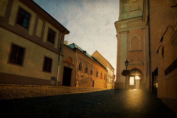 Early morning sun in an old city with grunge background
