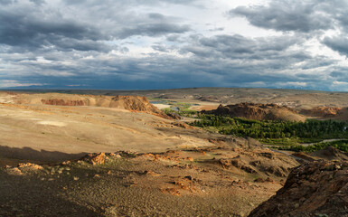 Fototapeta na wymiar Hills and rocks of the Chuya steppe, in the light of the setting sun.
