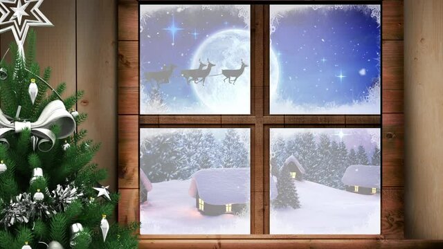 Digital animation of christmas tree and wooden window frame against snow falling