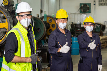 Leader engineer and partnership wearing protective uniform and hardhats in industrial team teamwork.