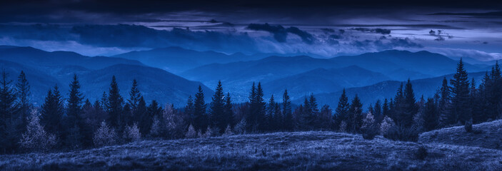 Panorama of misty carpathian mountains at night