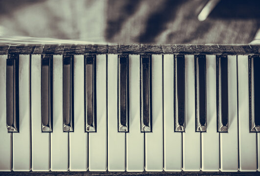 Old piano keys close up. Vintage photo.