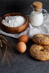 Flour, milk, eggs at dark background. Ingredients for bakery