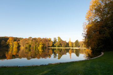 Autumn colors at lake Kahnweiher in Cologne with meadow.