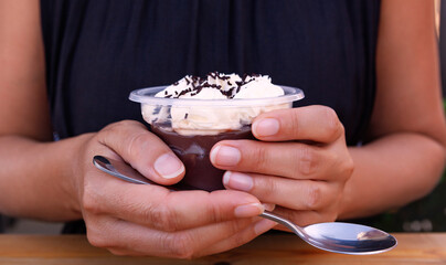 Woman eating chocolate pudding.