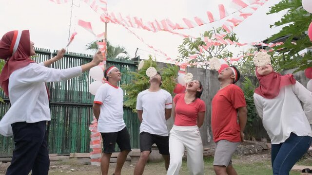 cracker eating competition on Indonesia's Independence Day celebrations in the field with decorated flags