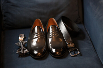 Morning details of a stylish groom with leather shoes