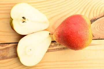 Ripe organic yellow-red pears, close-up, on a wooden table.