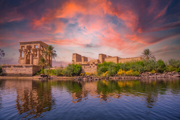 Incredible orange sunrise at the temple of Philae, a Greco-Roman construction seen from the Nile...
