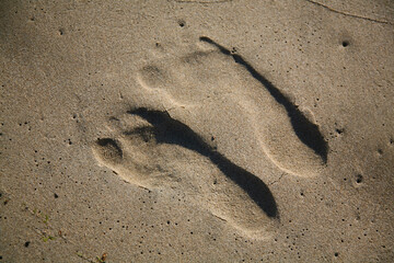 Fototapeta na wymiar human footprints on the sand
