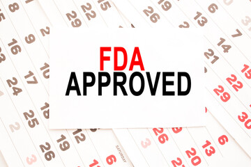 text FDA APPROVED on a sheet from Notepad.a digital background. business concept . business and Finance.