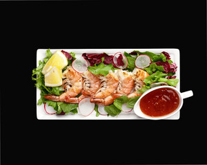 grilled shrimp with vegetables and sauce top view. High quality photo