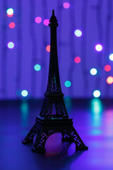 Miniature of the Eiffel Tower. Eiffel Tower in the New Year. The Eiffel Tower against the backdrop of shining garlands. 