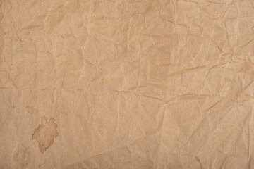 Brown crumpled paper with stains for background
