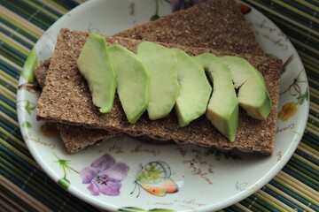Green avocado with bread on breakfast food 