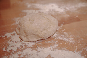Woman sculpts homemade dumplings bear ears in the kitchen. Modeling dumplings closeup. Female hands sculpt dumplings.