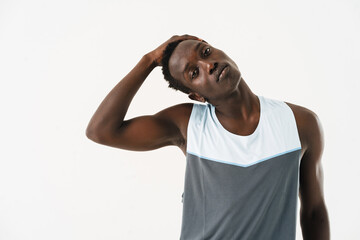 Young african american sportsman stretching his neck while working out