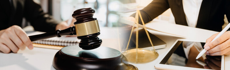 Business and lawyers discussing contract papers with brass scale on desk in office. Law, legal services, advice, justice and law concept picture with film grain effect