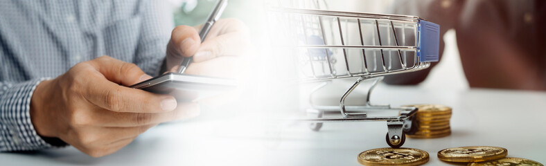 Business people use tablets and hold credit cards as an online shopping concept With a calculator and a book placed on the table