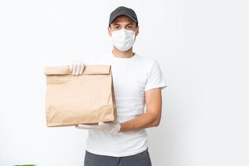 Delivery man holding cardboard boxes in medical rubber gloves and mask. copy space. Fast and free Delivery transport . Online shopping and Express delivery . Quarantine