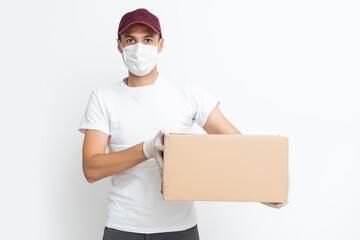 Fototapeta na wymiar Delivery man holding cardboard boxes in medical rubber gloves and mask. copy space. Fast and free Delivery transport . Online shopping and Express delivery . Quarantine