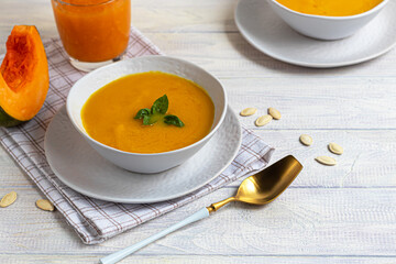 Fresh pumpkin cream soup with sour cream. Autumn lunch concept. A dietary, healthy dish.