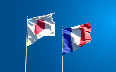 Beautiful national state flags of Japan and France together at the sky background. 3D artwork concept.