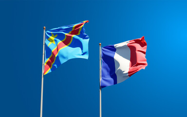 Beautiful national state flags of Democratic Republic of the Congo and France together at the sky background. 3D artwork concept.