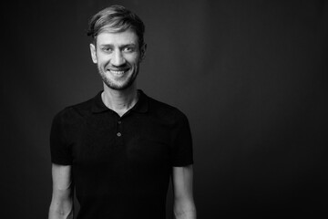 Studio shot of blond bearded man against gray background
