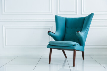 blue soft armchair is in white room