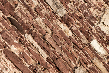 Naklejka premium stone old wall. brickwork on the building. brown loft-style surface. dark creative background. clinker texture