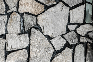 Obraz premium stacked huge cobblestones. texture with boulders. wall with gray stones. creative light background