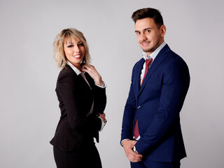 Business personnel are shown smiling and with positive and confident aptitude