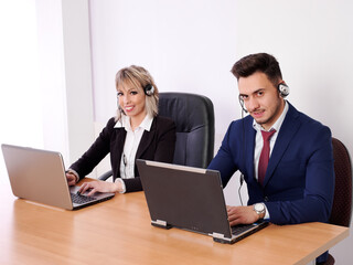 Fototapeta premium Operators with positive aptitude answering customer calls