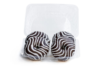 Chocolate ripple stripe doughnut in plastic container isolated on white