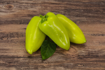 Green bell pepper over wooden background