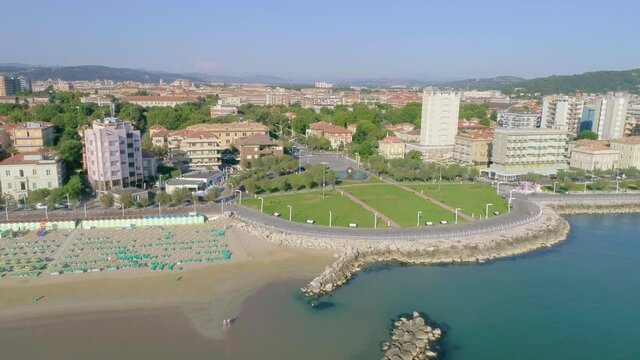 Aerial top view of the Piazzale della Libert&agrave; in Pesaro (marche), with the sculpture Sfera Grande (Palla di Pomodoro) by Arnaldo Pomodoro and the Viale della Repubblica, coast with colored umbrellas