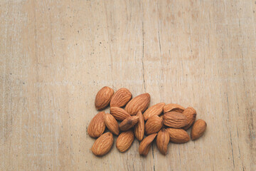Almonds are placed on the wooden floor at the bottom of the image,vegetarian food, copy space.flat lay,top view,top down.