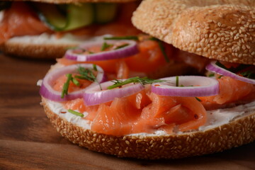 Bagel sandwich with salmon, cream cheese, cucumber, and onions