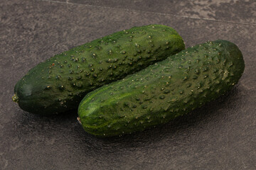 Green fresh cucumbers over background