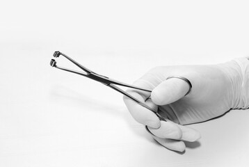 Hand holding razzhy for clamp for piercing