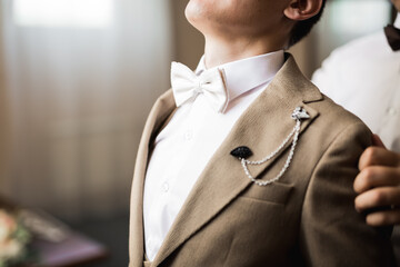 Grooms morning preparation. Handsome man getting dressed and preparing for the wedding